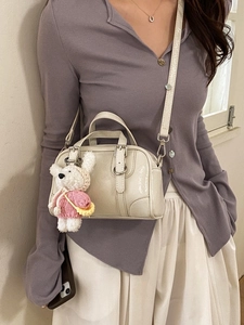 Minimalist cream PU handbag with cute plush bear charm and detachable crossbody strap