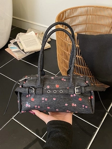 Retro denim barrel handbag with red rose floral pattern and metallic belt details