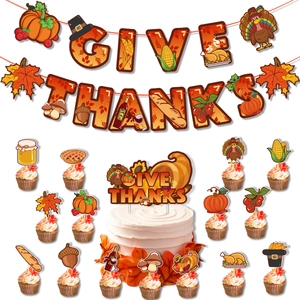 Detail view of Give Thanks banner and cupcake toppers with harvest turkey and pumpkin motifs