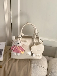 Minimalist cream shell handbag with heart charm and a cute plush rabbit accessory
