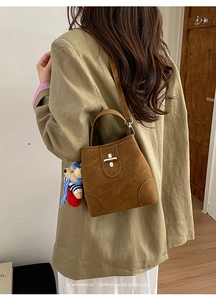 Brown frosted bucket bag with silver turn-lock and cute blue crochet bear charm