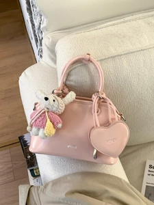 Pink trapezoidal shell bag with heart coin purse and plush bear charm for casual styling