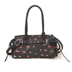 Floral denim shoulder bag with red roses and cherry prints on dark grey fabric background