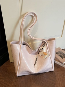 Pink patent leather tote bag with stylish horse charm charm for office commuting