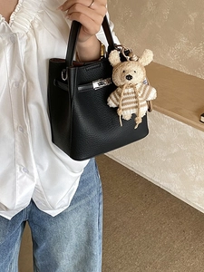 Retro black lychee leather bucket bag with metal buckle closure and cute bear charm