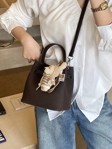 Vintage dark brown pebble leather bucket bag with cute bear charm and shoulder strap