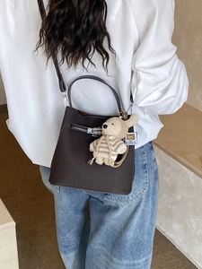 Retro dark brown bucket bag with litchi texture and a cute bear pendant for women