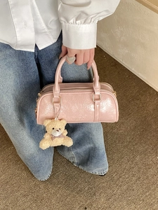 Pink crinkled patent leather Boston handbag with a cute teddy bear charm and gold hardware