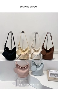 Minimalist leather bucket bags in six colors displayed on racks with a mini pouch detail