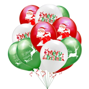 Close-up of red, white, and green Christmas balloons with Santa and reindeer prints
