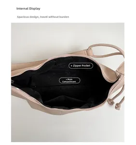Detail of the beige crossbody bag interior featuring a zipper pocket and black lining
