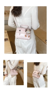 Detail of pink polka dot handbag with leopard print charm and Shengtaos logo