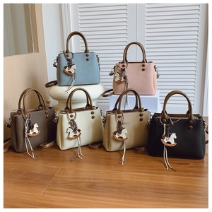 Six colorful tote bags displayed on white pedestals with stylish horse pendants