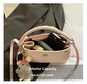 Interior view of the pink leather handbag showing capacity for phone and cosmetics