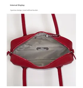 Interior view of red shoulder bag with herringbone fabric lining and zipper pocket