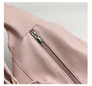 Detail of pink faux leather bag showing gold zipper and solid metal puller construction