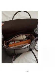 Detail view of the spacious dark brown leather handbag interior with daily essentials