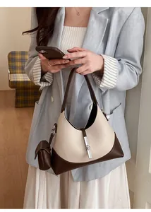 Detail of hobo bag with contrast lychee texture leather and silver metal buckle