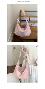 Detail view of pink large capacity leather tote bag with cute white horse charm accessory