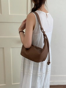 Minimalist soft leather dumpling shoulder bag in dark brown with elegant knot detail