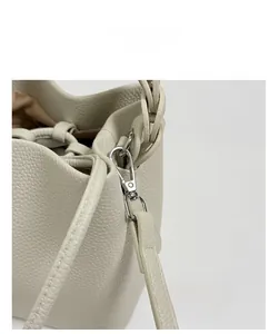 Close-up of premium lychee grain leather finish with silver spring clip hardware details