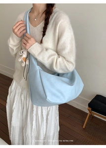 Close-up of sky blue large capacity tote bag with white animal charm decoration