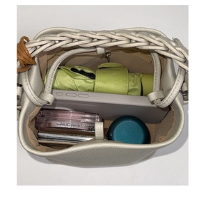 Top view of spacious bucket bag interior with zipper pocket showing daily essentials