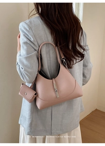 Detail of dusty rose hobo bag with silver piston clasp shown on model