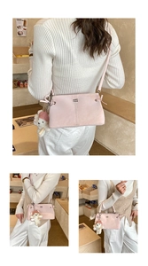 Pink crossbody bag detail showing matte texture and cute plush bear charm on strap