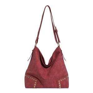 Deep red hobo shoulder bag in suede leather with gold square rivets on bottom edges