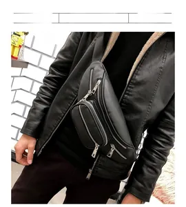 Close-up of black leather chest bag with silver zippers shown on a male model