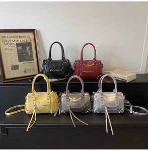 Detail view of colorful rivet pillow bags with leather tassels and metallic studs