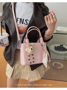 Detail of pink retro mini handbag with plush bear charm and printed silk scarf handle