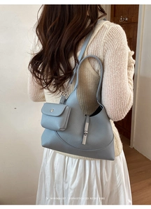 Detail of blue leather dumpling bag with silver buckle and matching mini coin purse