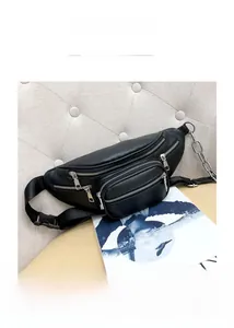 Close-up of a black multi-pocket waist bag featuring silver chain decor and textured finish
