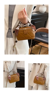 Detail of brown quilted mini handbag with silk scarf handle and adjustable gold chain