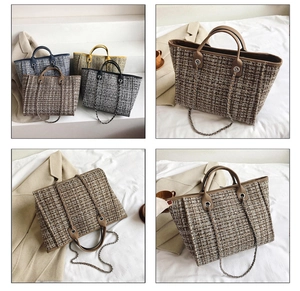 Detail shot of large tweed tote bag showing woven texture and dual leather handles