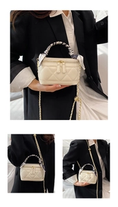 Detail of quilted mini handbag with silk-wrapped handle and gold chain strap