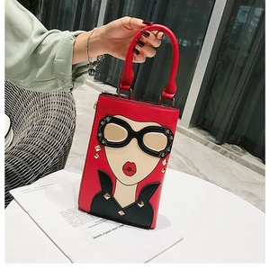 Gros plan d'un mini sac à main rouge stylé avec motif fille et rivets dorés