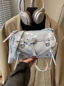 Chic light blue patent leather Boston bag with decorative straps and silver buckles
