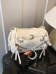 Chic white Boston bag with edgy silver hardware and long tassels for a modern street style