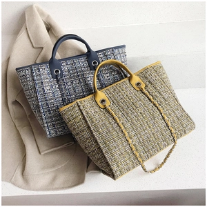Detailed close-up of woven tweed bucket bags with leather handles and chain straps