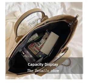 Detail view of large khaki tote bag showing spacious interior with personal essentials