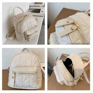 Detail view of cream quilted mini backpack featuring gold hardware and rhombus pattern