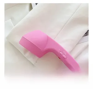 Close-up of pink telephone handset bag side showing functional volume control buttons