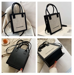 Detail view of mini two-tone leather and canvas tote bag with elegant round handles