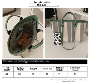 Detailed sizing chart and interior layout for the striped canvas bucket tote with leather handles