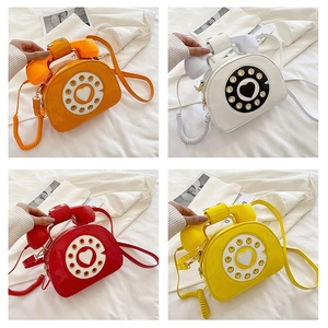 Multi-angle views of retro telephone crossbody bags in vibrant orange, white, red, and yellow