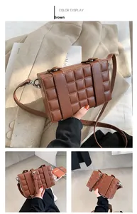 Detail of a brown leather box bag with quilted rhombus pattern and silver buckle