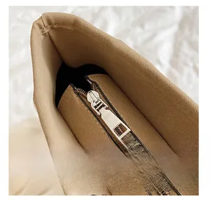 Detail view of khaki suede bucket bag featuring a premium light gold metal zipper